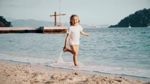 Happy Girl Runs Barefoot on the Sand Beach
