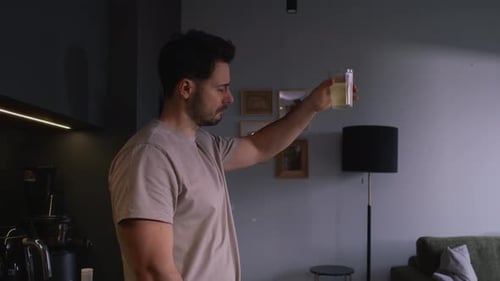 Man drinking electrolytes in the kitchen