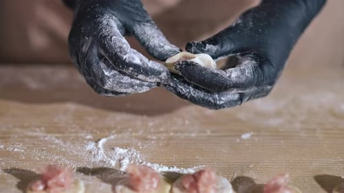 Hands in Gloves Making Fresh Dumplings