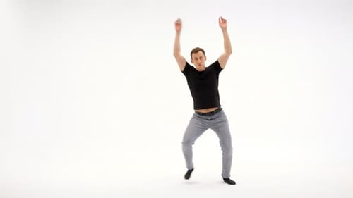 Young Adult Man Energetically Dancing in White Studio