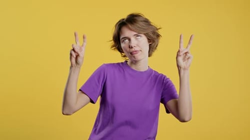 Woman Gesturing and Expressing Frustration on Yellow Background