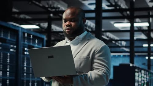 Data Center Computer Scientist Using Laptop to Manage System Stability