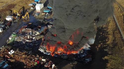 Fire Huge Fire at a Car Junkyard Black Smoke Pollutes the Atmosphere Ecological Disaster Global