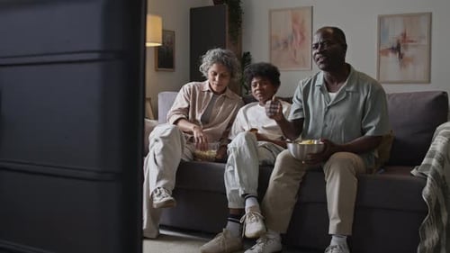 Family Enjoys Watching TV Together at Home