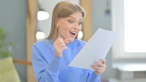 Young Woman Reads Good News on Paper