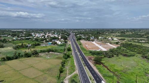 Aerial view of vehicles moving along Chennai’s main highway amidst the urban sprawl