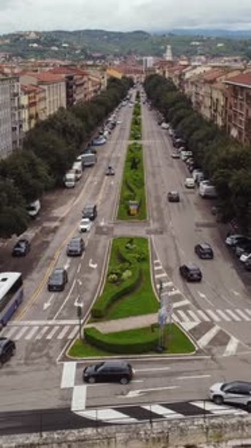 Vertical View of Verona's Busy Avenue with Daytime Traffic