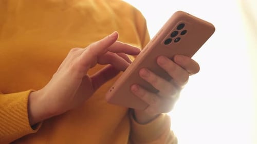 Hands Using Modern Mobile Phone Indoors