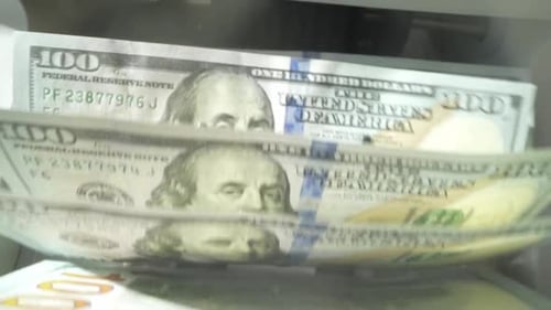 Finance and Cash Dollars Concept Counting Dollars with Electronic Money Counter Machine 100 Dollar