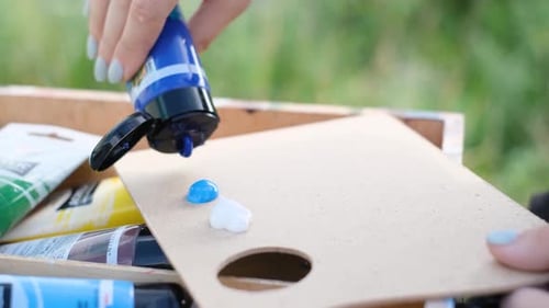 Artist Preparing Paint on Palette Outdoors Close Up