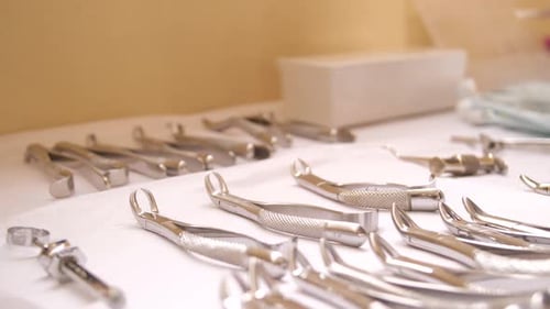 Dental Instruments Lying on White Surface