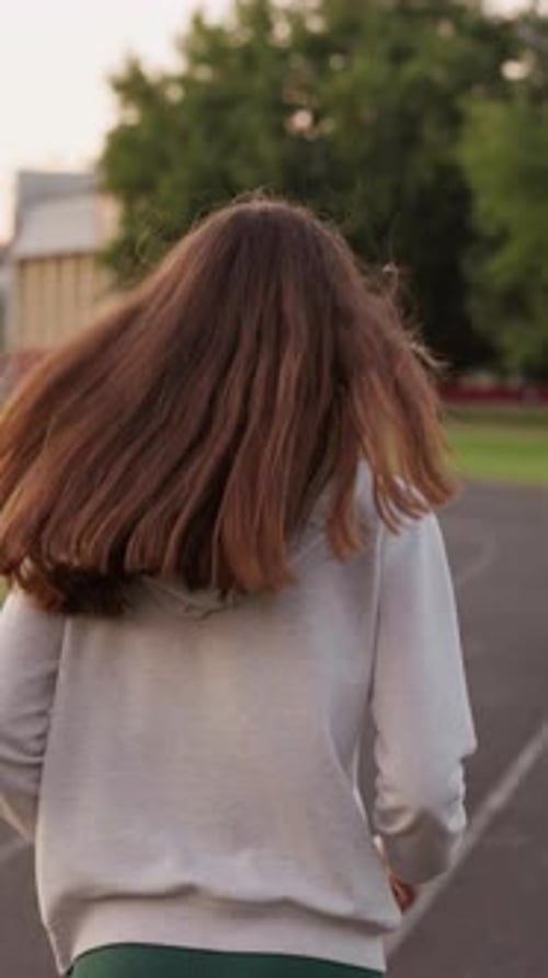 Woman Jogging Along Sport Stadium Track