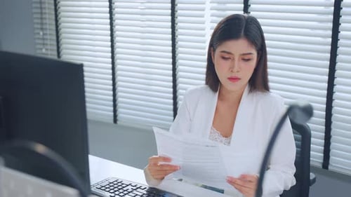 Asian beautiful businesswoman using laptop computer working in office.