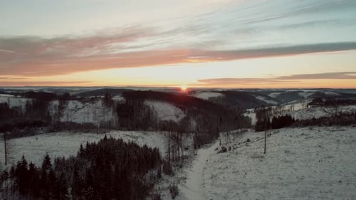 Winter Wonderland: Sunrise Over Snow Covered Hills