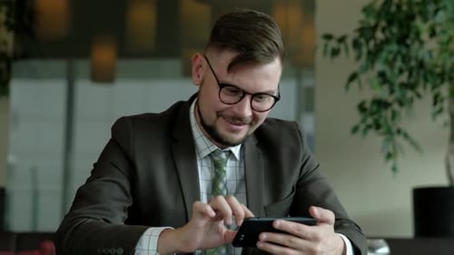 Businessman smiling looking at the phone