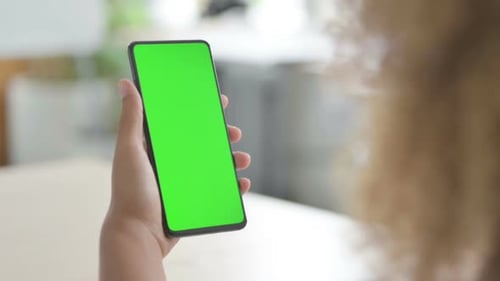 Close Up of African Woman Using Smartphone with Green Screen
