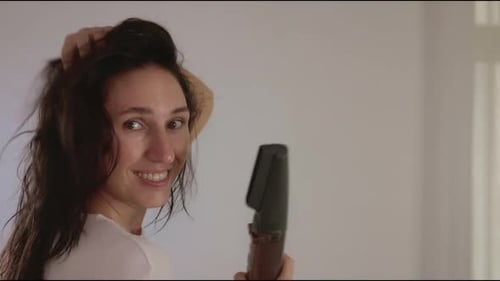 Smiling Woman Using Hair Dryer in Home Interior
