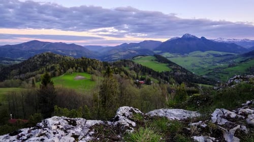 Hilly Mountain Countryside Scenery with Forests and Meadows and Mountains in Rich Spring Colors