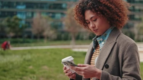 Young Woman Using Smartphone and Drinking Coffee