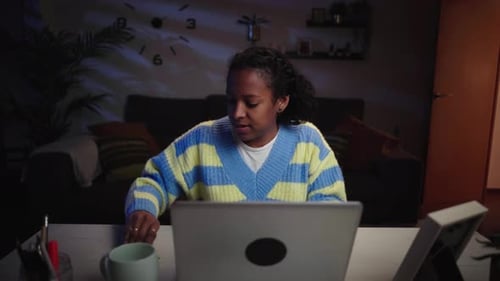 Woman Using Laptop with Credit Card at Night