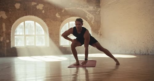 Male Gymnast Doing Fitness in the Solar Hall Sports and Gymnastics Warmup for Muscle Stretching and