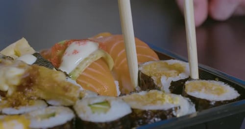 Picking Sushi Up with Chopsticks, - close up slow motion