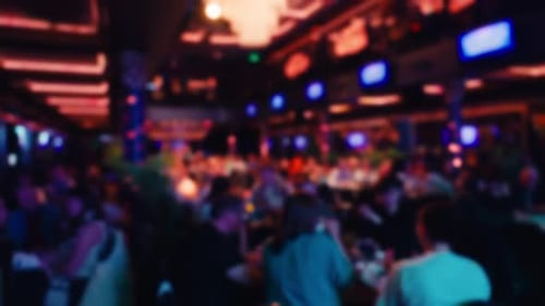 A Lively Restaurant Scene with Colorful Lighting Joyful Ambiance and People Socializing on a