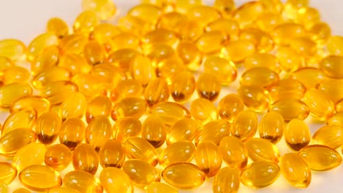 Fish Oil Capsules Rotating. Healthy Background and Medicine Concept. Omega 3 Natural Fat in Healthy
