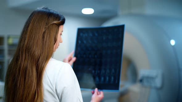 Woman doctor with x-ray photo. Young female doctor examines radiology ...