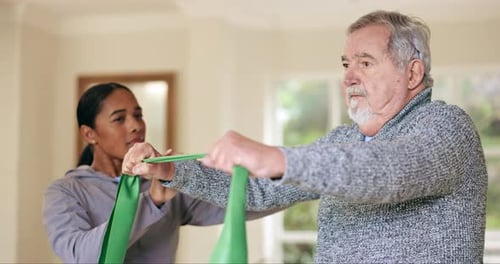 Senior Man Exercising with Resistance Band with Assistance