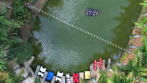 Aerial panning shot of a beautiful marina full of colorful boats and then showing the surroundings w