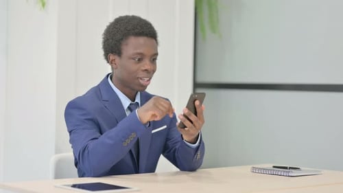 Young Adult Celebrating Good News on Phone