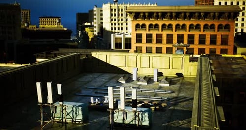 Construction Activity on a Rooftop in an Urban Area During Evening Light