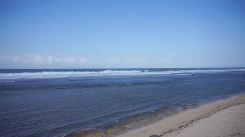natural panorama, with sea water and waves on the seashore under clear blue sky during the day