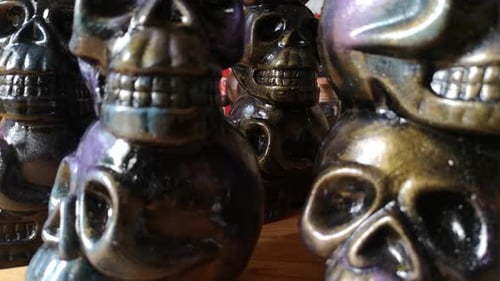 Multicoloured painted ceramic spooky death skull totem crafts pottery ornament dolly left closeup