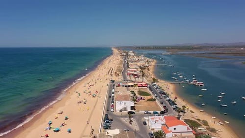 Aerial View of the Ocean Coast and Beach Boats on the Water and Tourists Relaxing on the Beach As