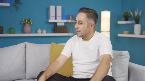 Man Meditating and Praying in Indoor Setting