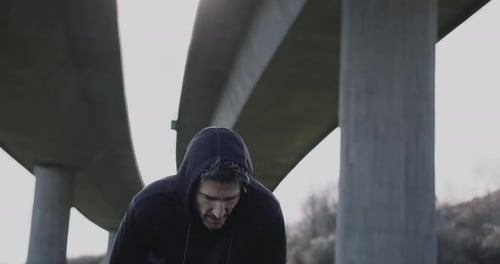 Adult man running athlete sprinting workout challenge training endurance in urban city