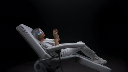 Woman Using Futuristic Technology in Medical Chair