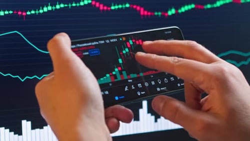 Hands Analyze Stock Charts on Phone