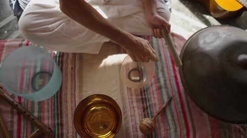 Hands of Unrecognizable Man Playing Tibetan Bowl in Sound Healing Session