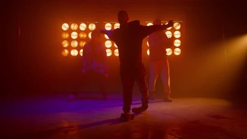 Man Dancing with Background Lighting Inside Dark Room