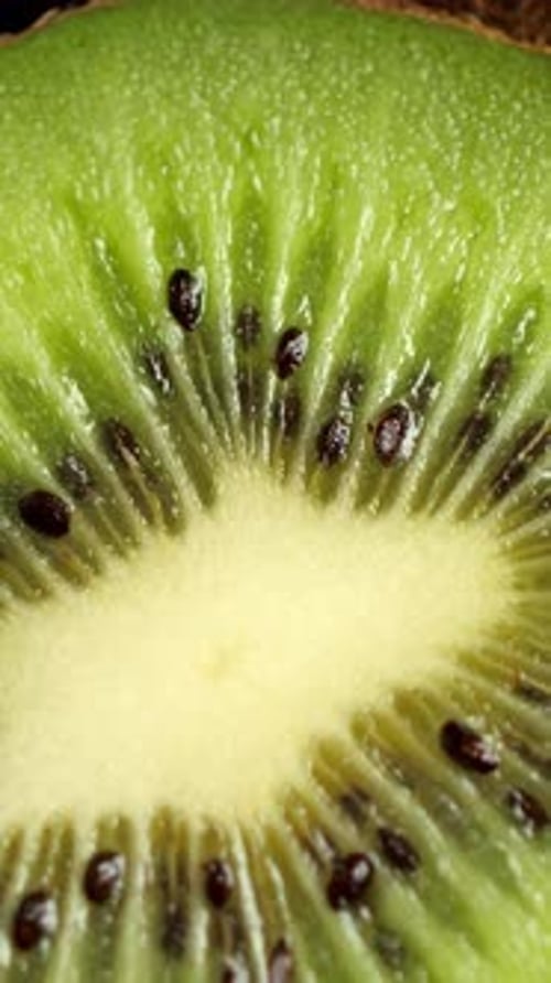 A Lot of Sliced Kiwi Rotating Ripe Tropical Fruits Closeup Vertical