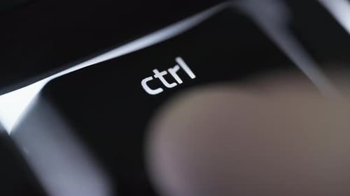 Pressing and holding the CTRL button on black computer keyboard