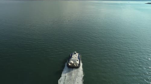 Hovercraft Leaving Wake On Sea Surface While Cruising From Portsmouth To Isle Of Wight In UK. aerial