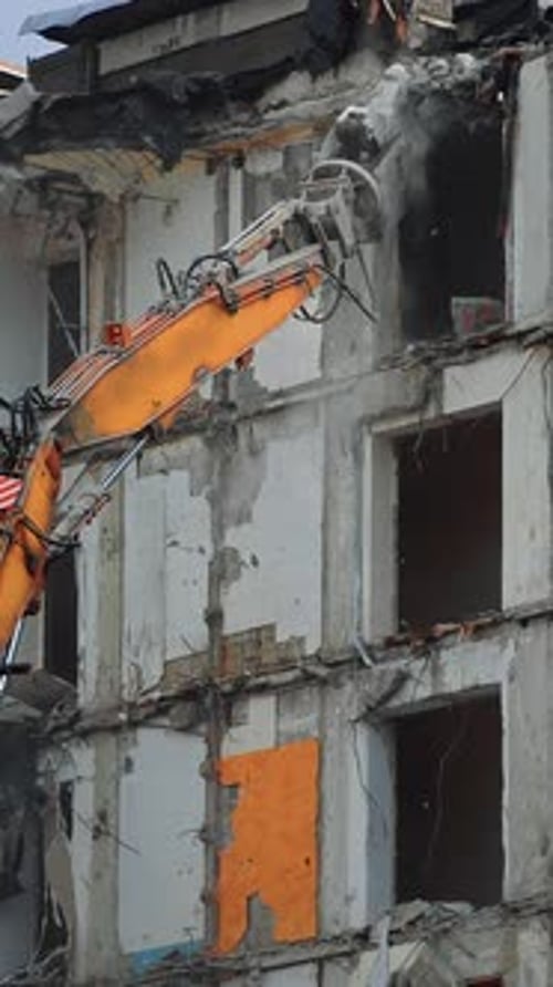 Dismantling the destroyed roof of a high building.