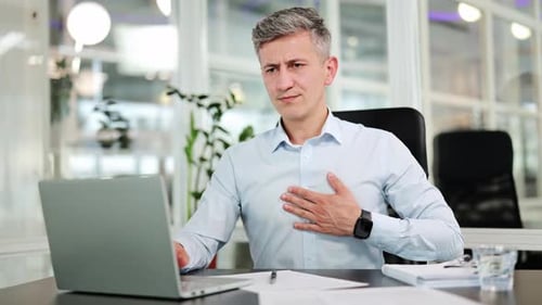 Man at Desk With Chest Pain