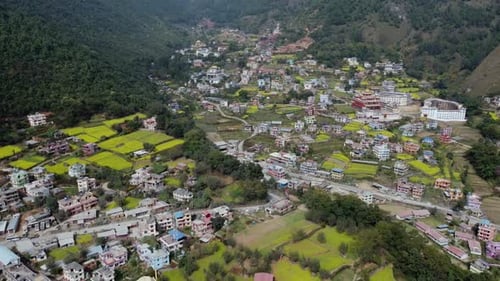 A beautiful aerial view of the small town of Dakshinkali, Nepal surrounded by mustard fields and the