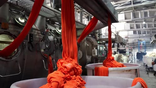 Bright Orange Textile Material in a Factory Setting