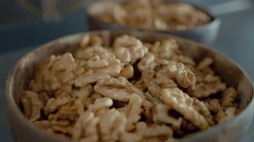 Shelled Walnuts Filling Bowls in a Home Kitchen
